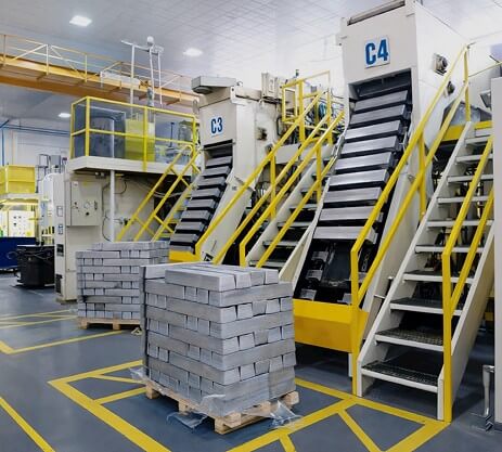 Die casting cell with stacked magnesium ingots ready for production
