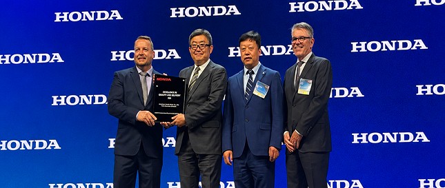 Meridian team accepting the Honda Excellence in Quality and Delivery Award on stage